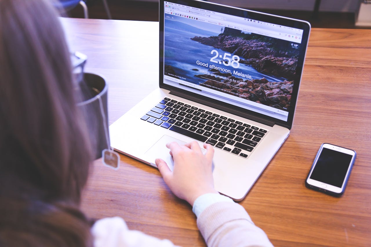 Person using a laptop with a browser open, ideal for remote work themes.